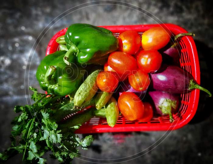 A basket full of fresh vegetables bought from market, washed with hot salt water and kept for drying as precautionary measure to avoid Covid-19 Virus