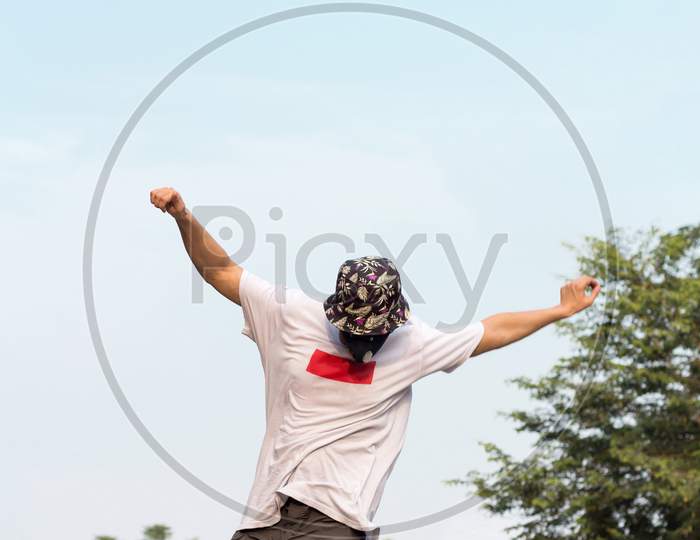 A Young Adult Wearing A Protective Mask While Doing Freestlye Stunt.