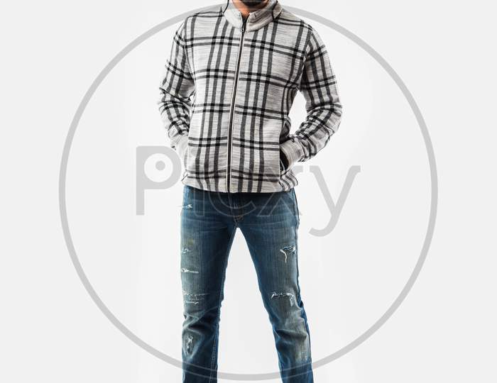 Indian bearded man in winter clothing presenting or standing isolated over white background