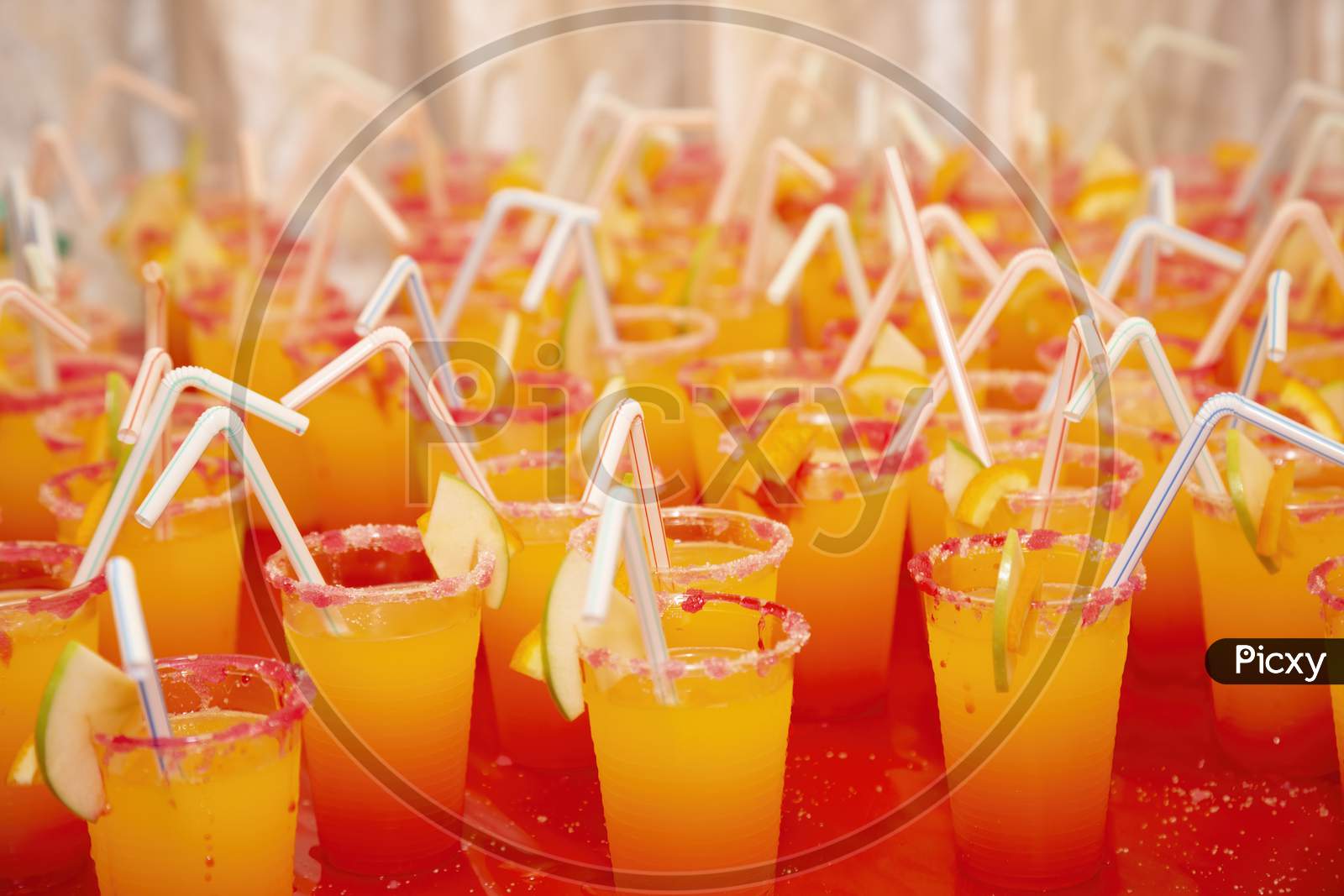 yellow orange juice cocktail with straw for wedding reception