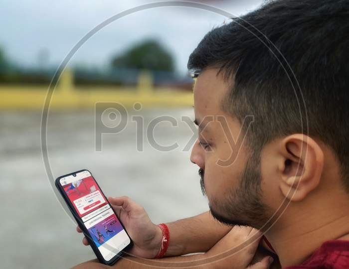 A young boy looking at mobile phone