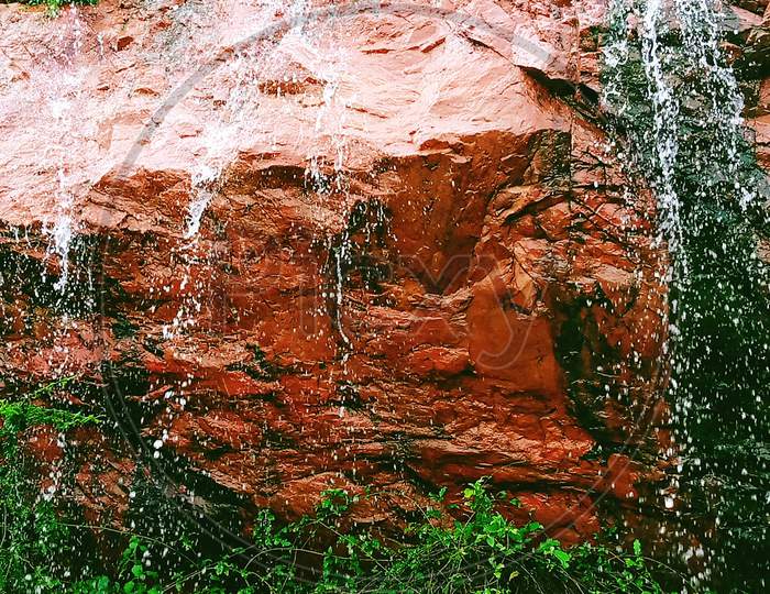 Water Flowing From The Red Rock