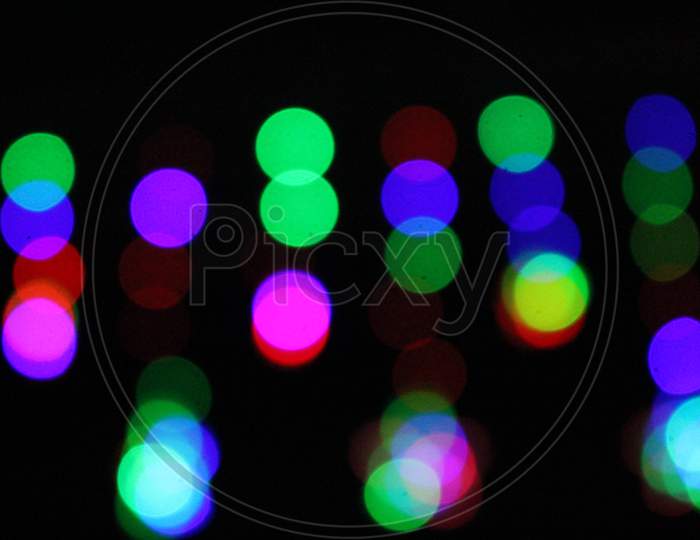 Background Bokeh Stars Flashing Colored Elements on a Black Background in the Wind, Night