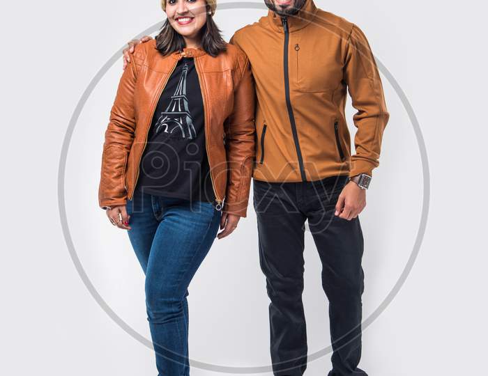 Indian young couple in winter wear /warm clothes against white background