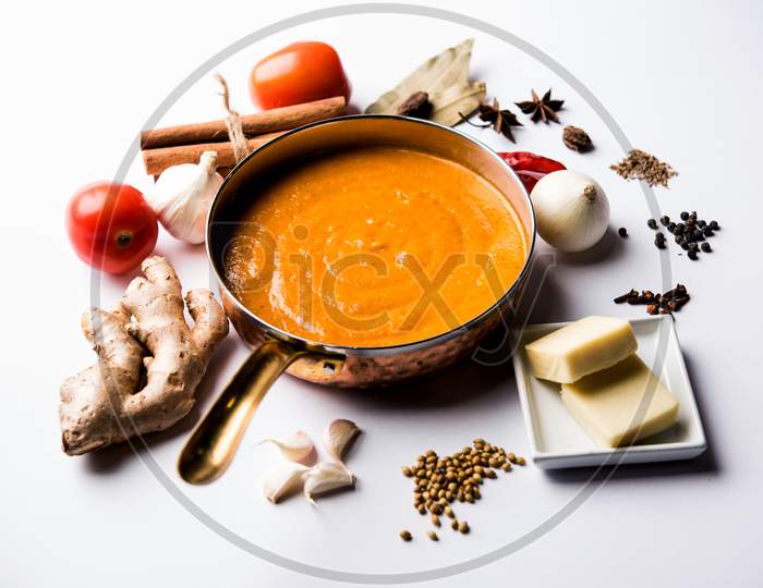 North Indian basic Curry for paneer butter masala or chicken makhanwala recipe shown with ingredients, served in a bowl. selecti