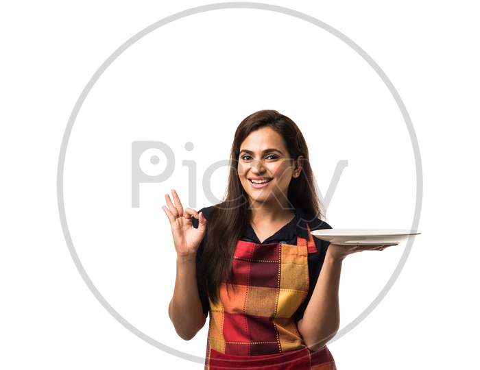 Indian girl holding empty white plate