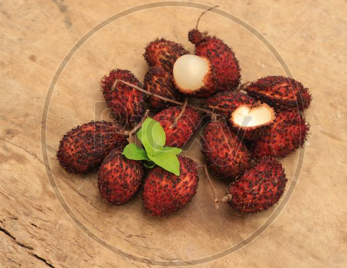 Rambutan or Nephelium Lappaceum Fruits isolated with Wooden Background