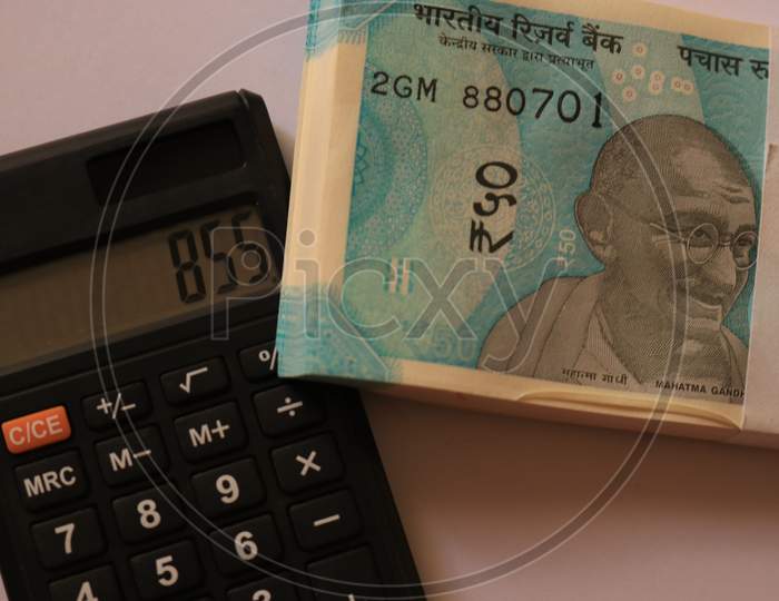 Indian Currency Notes with Calculator isolated with White Background