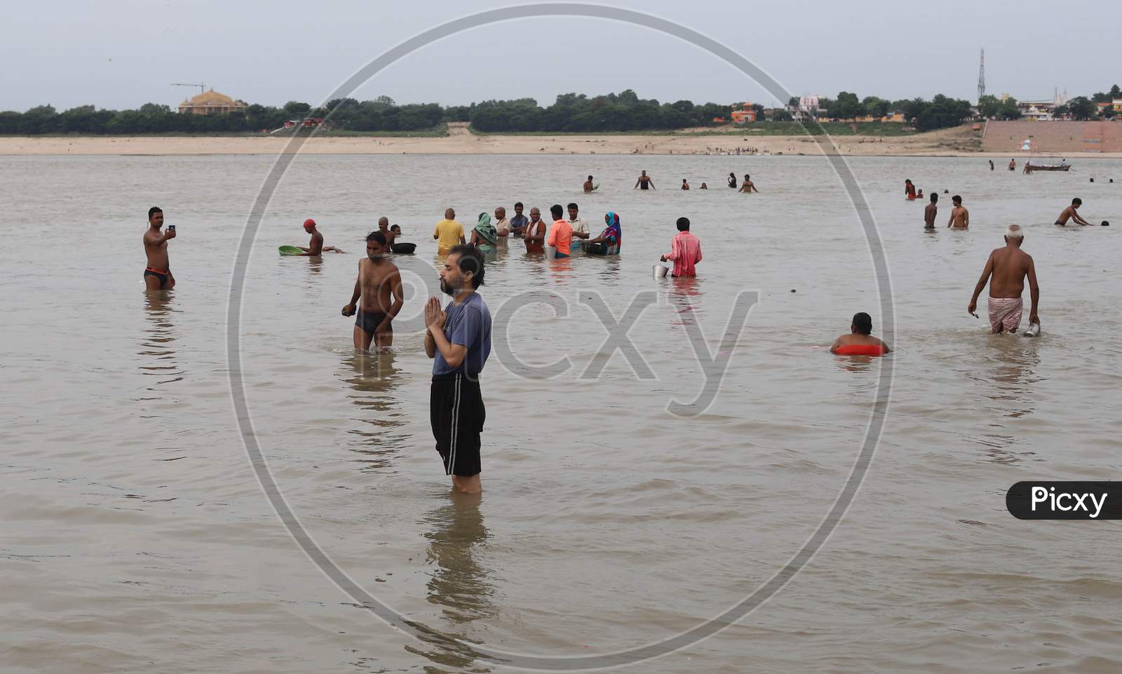 Devotees take a dip in the Holy River Ganga on the first Monday of the holy month of Shravan in Prayagraj, Uttar Pradesh on July 13, 2020
