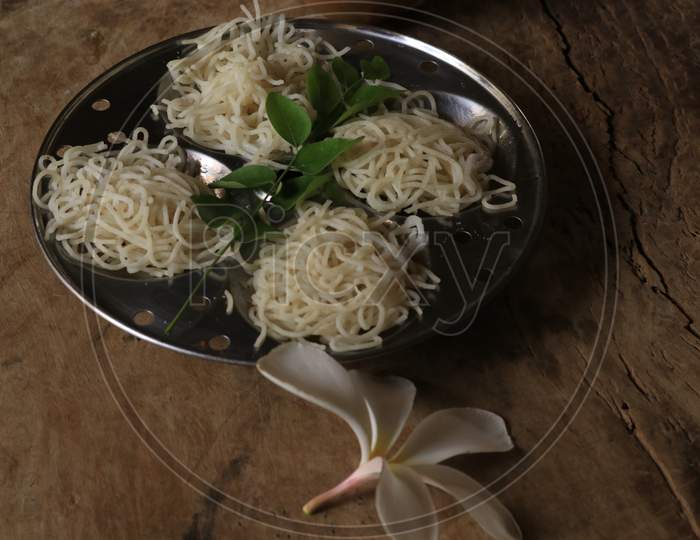 Rice Noodles in Idly Plate Isolated with Wooden Background