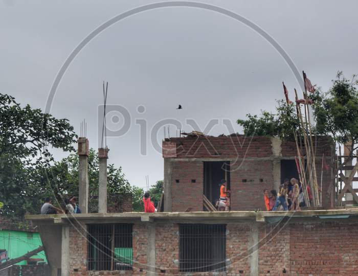 Kids playing on roof of Under Construction house