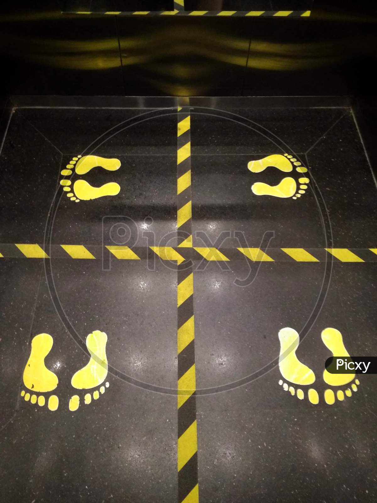 Footwear stickers that indicate the direction of a person must stand facing his body when using the elevator in the new normal era