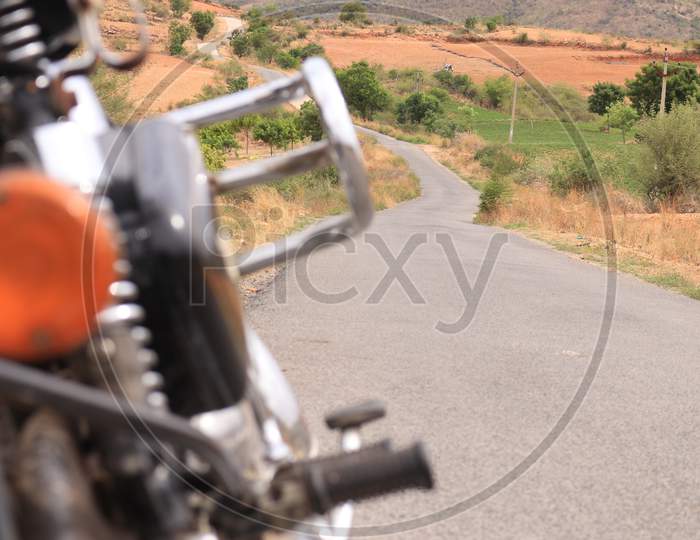Selective on Single Lane Road with Royal Enfield Bike in the Foreground