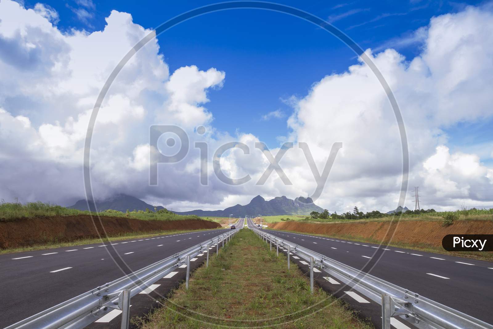 dual carriageway with cloudy blue sky