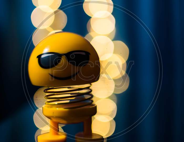 A Yellow Colored Toy With Bokeh Background