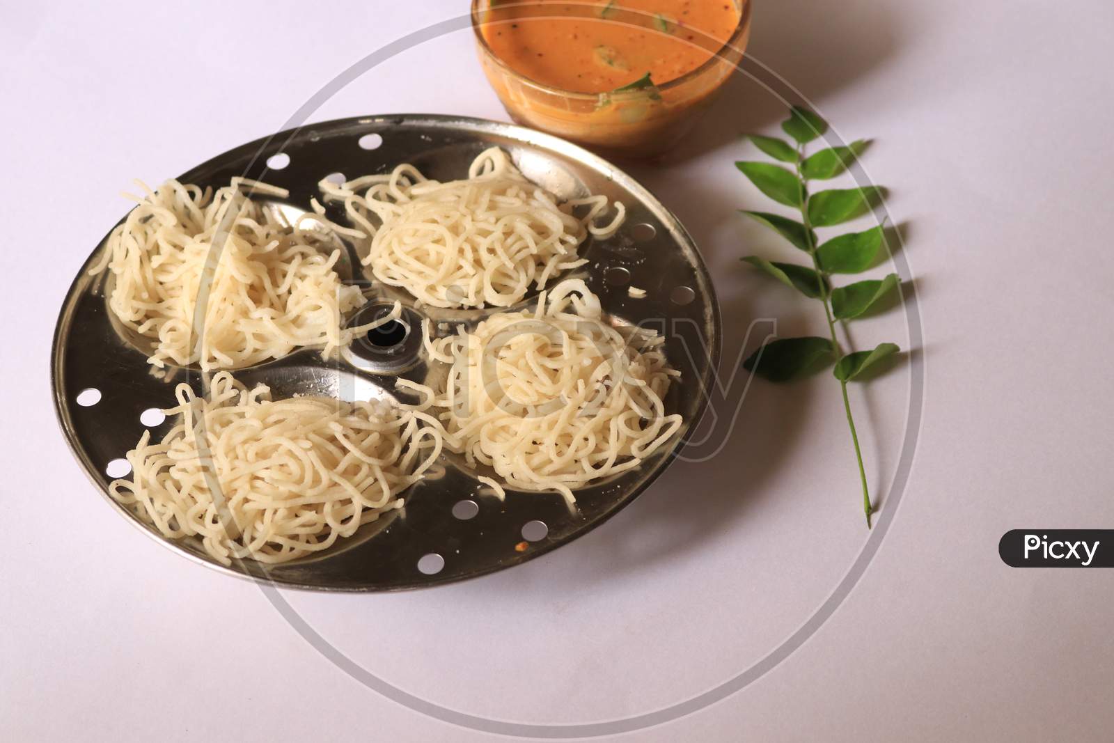 Rice Noodles in Idly Plate with Curry isolated with White Background