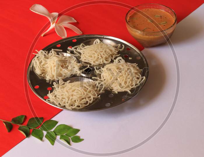 Rice Noodles in Idly Plate with Chutney Isolated with Red and White Background