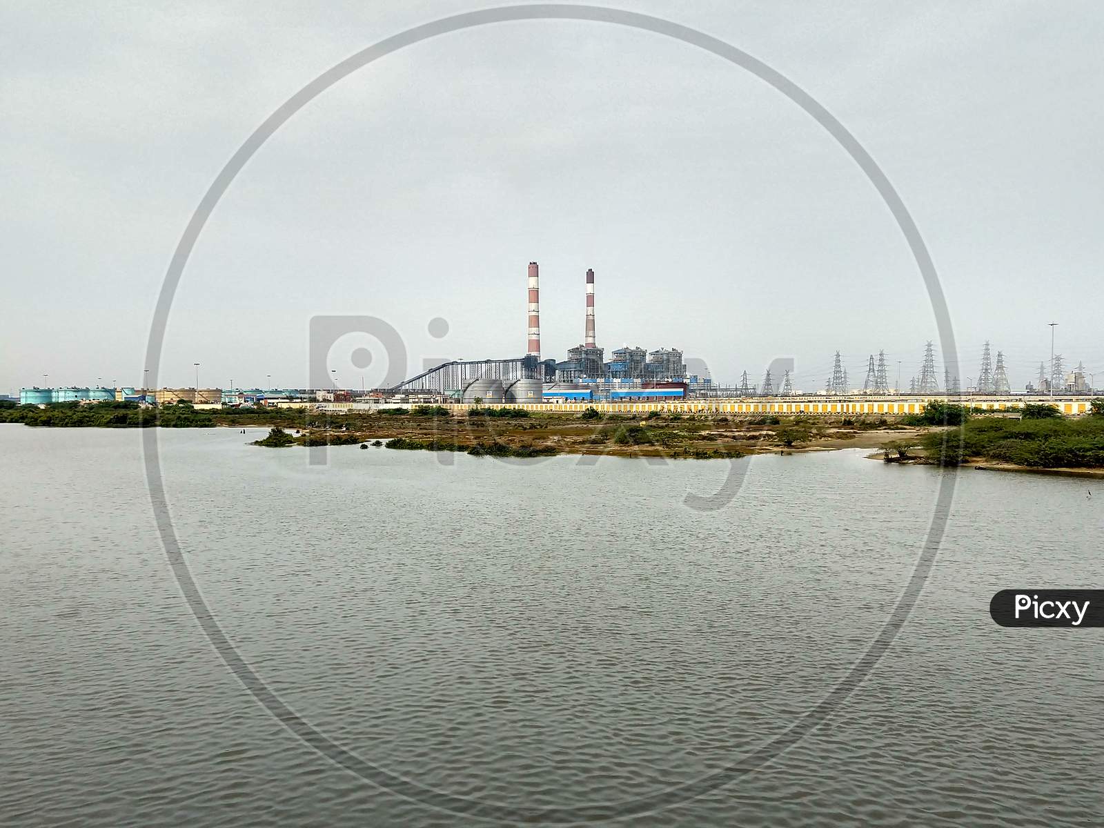 A Large Thermal Power Plant On The Banks Of The Kosasthalaiyar River At Chennai. Two Long Chimneys Are Clearly Visible.