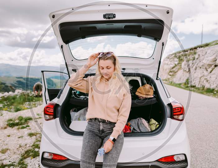 Attractive Woman Travel By Car In Mountains