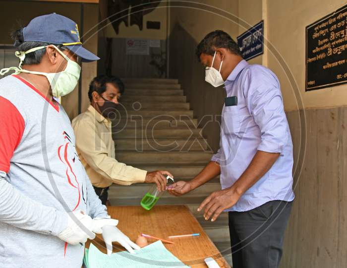 People coming to "Purba Bardhaman Zilla Parishad" are entering inside after following the hygiene rules to prevent COVID-19 infection.