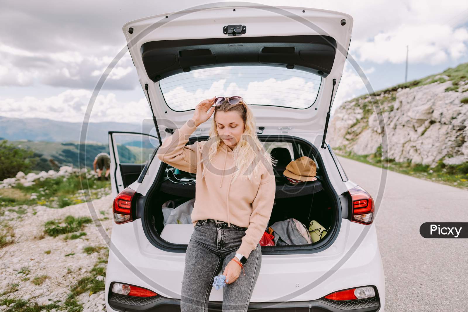Attractive Woman Travel By Car In Mountains