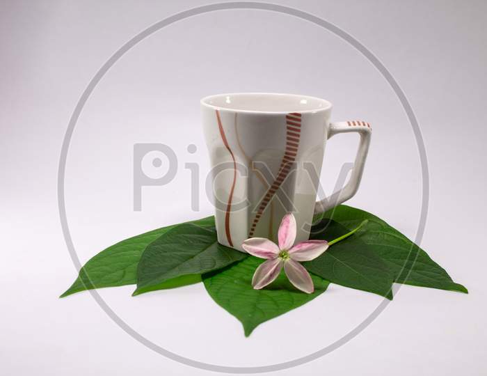 Tea or coffee cup with flowers and leaves