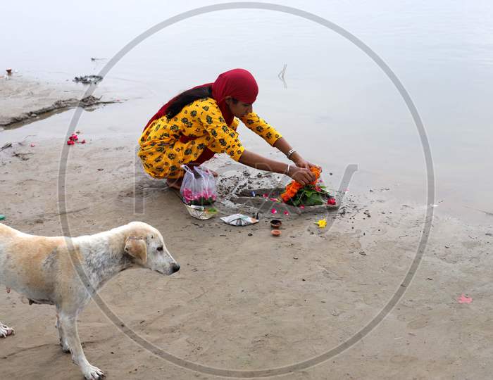 A devotee offer prayers on the first Monday of the holy month of Shravan on the banks of the River Ganga to Lord Shiva in Prayagraj, Uttar Pradesh on July 06, 2020