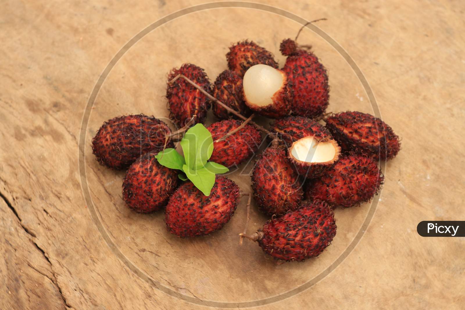 Rambutan or Nephelium Lappaceum Fruits isolated with Wooden Background