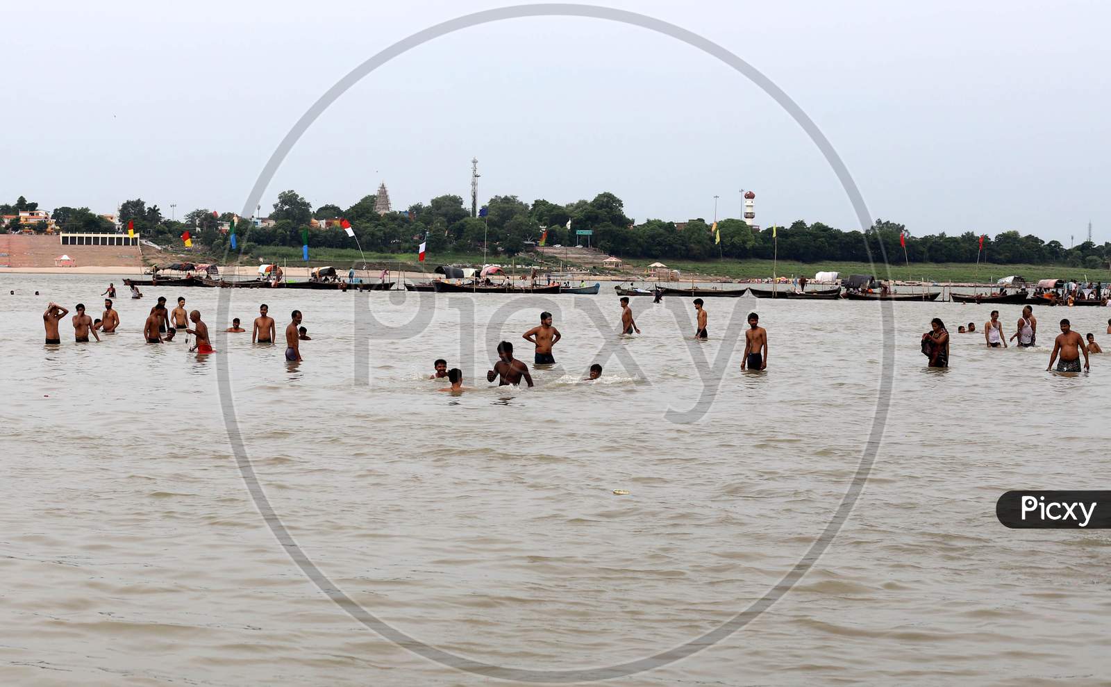 Devotees take a dip in the Holy River Ganga on the first Monday of the holy month of Shravan in Prayagraj, Uttar Pradesh on July 13, 2020