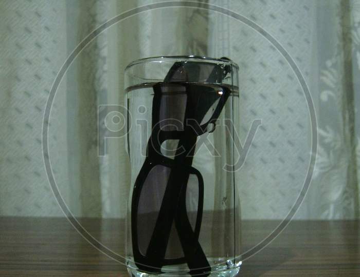Spectacles in a glass of water