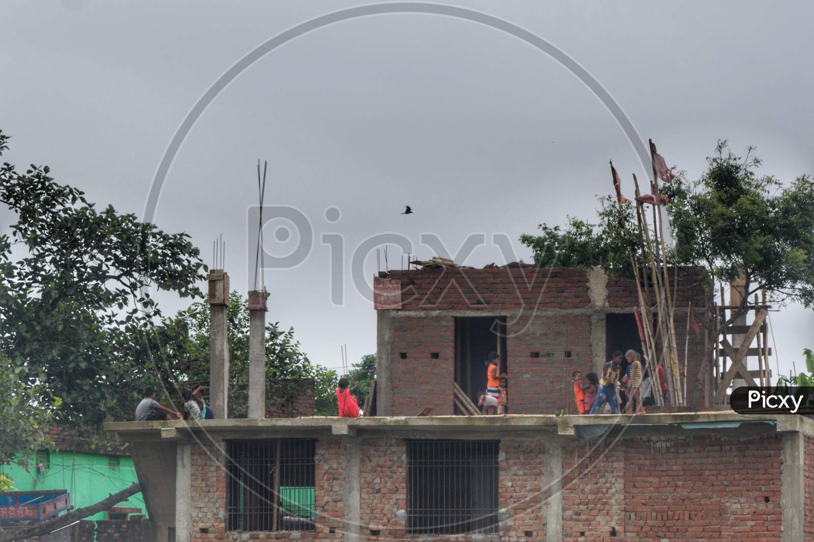 Kids playing on roof of Under Construction house