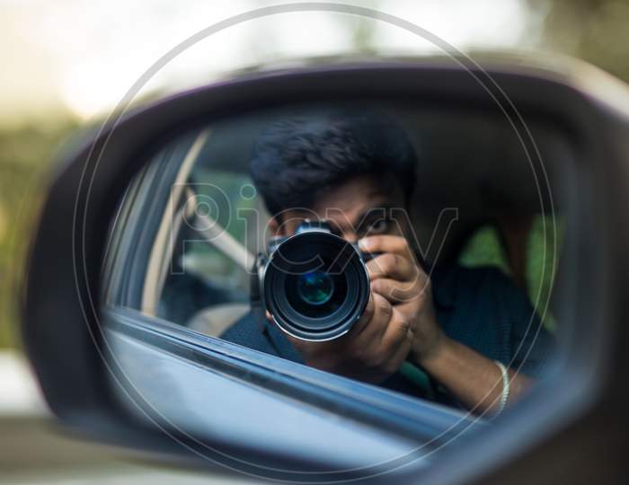 Photographer refection - rear view mirror