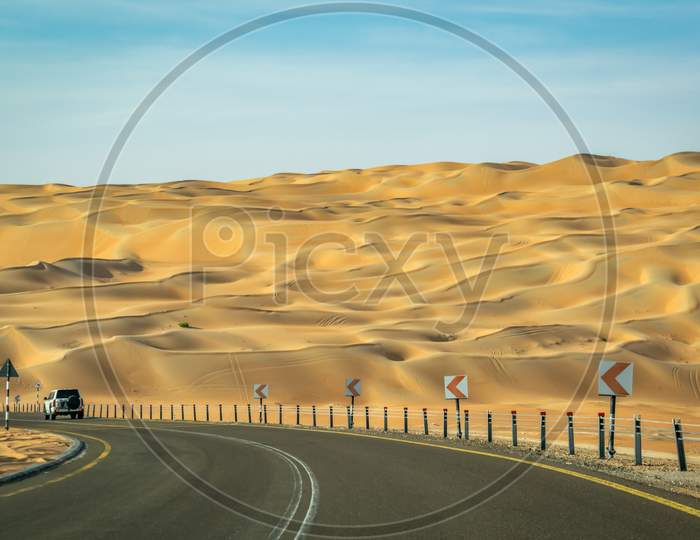 A Beautiful View Of Reoad Crossing Through Clean Sand Dune From Liwa Desert Abu Dhabi