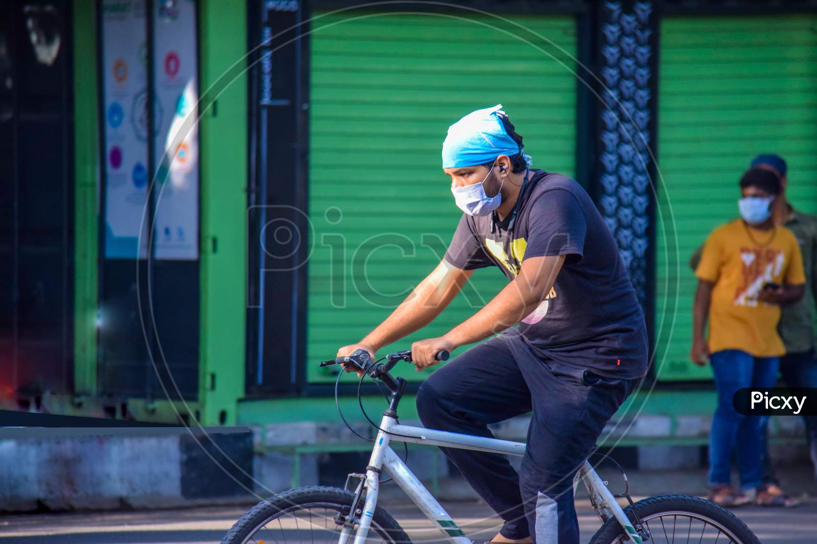 Hyderabad, Telangana, India. June-29-2020: Man With Protective Safety Mask On His Face Riding A Bicycle, Protective Mask Against Corona Virus
