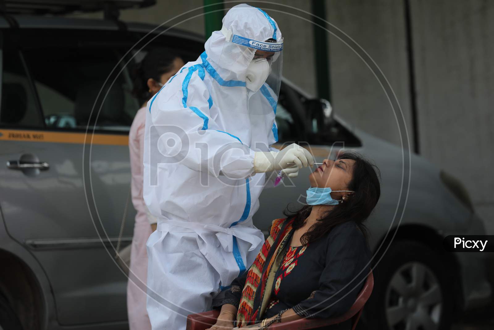A health worker collects swab samples of the employees working for Directorate of Agriculture for Covid-19 testing at the agricultural office in Jammu on July 14, 2020