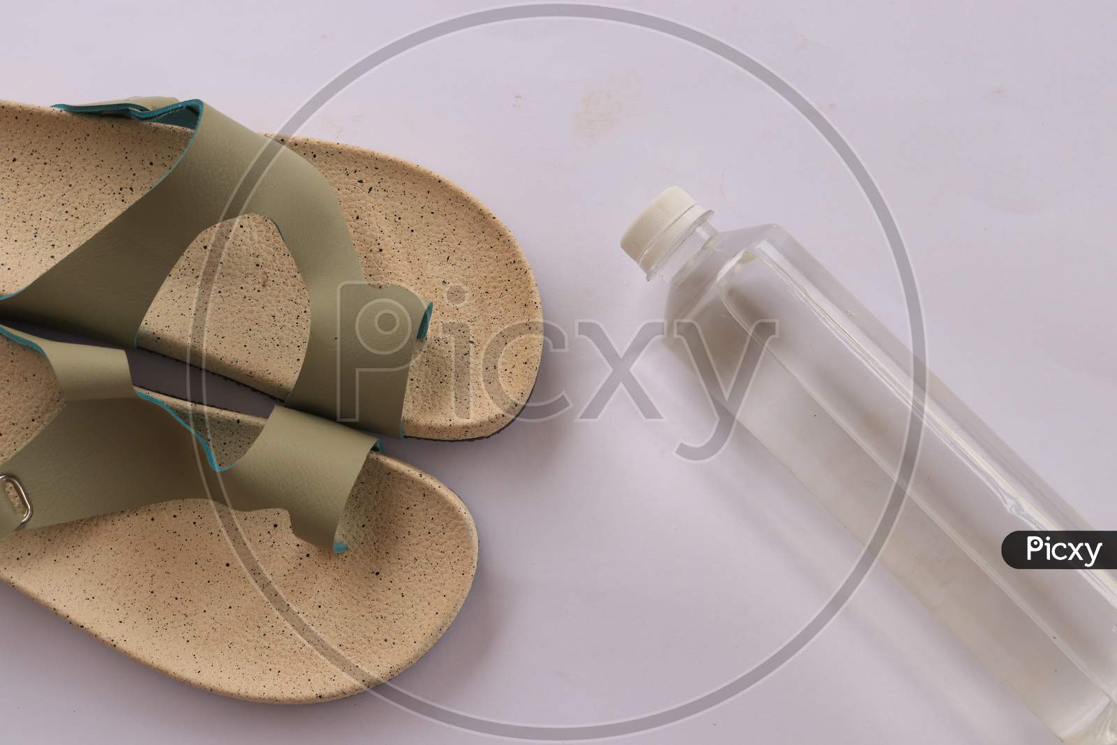 Slippers or Sandals with Water Bottle on White Background