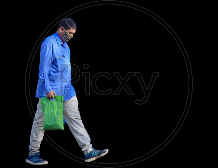 Hyderabad, Telangana, India. June-29-2020: An Older Man Is Walking On The Road. Man With Protective Safety Mask On His Face, Isolated On Black Background