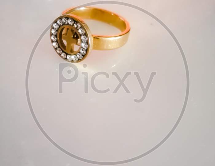A golden ring placed on a white background