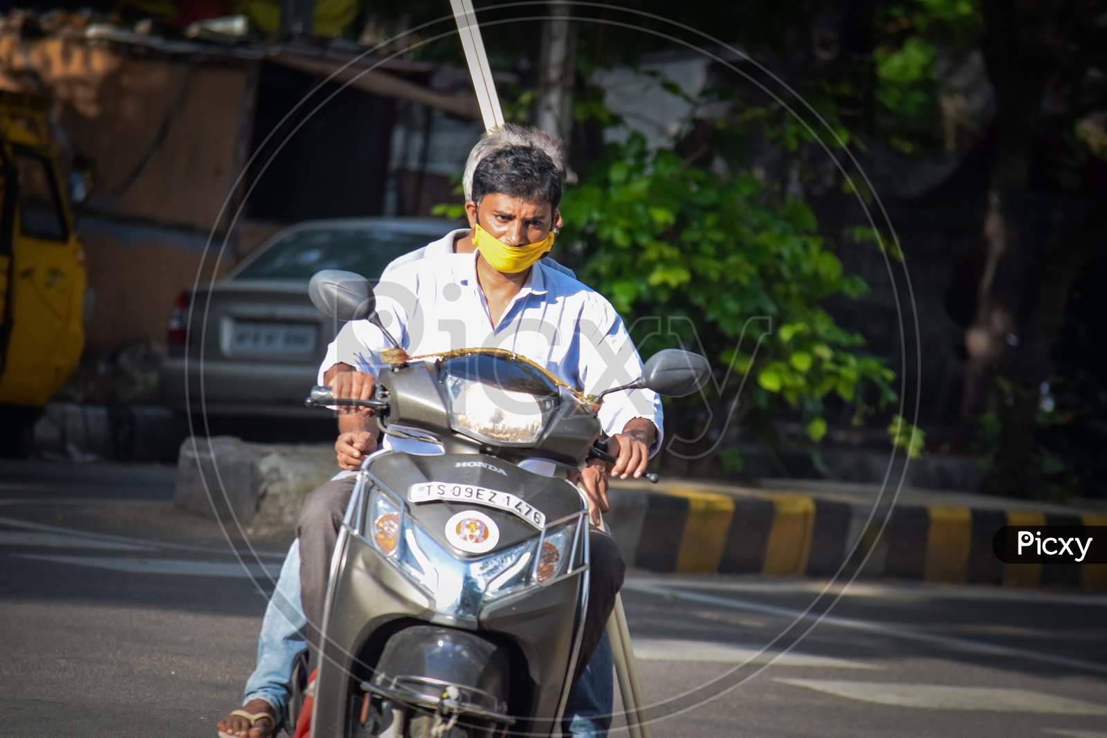 Hyderabad, Telangana, India. july-14-2020: man with protective safety mask on his face riding a motorbike, protective mask against corona virus
