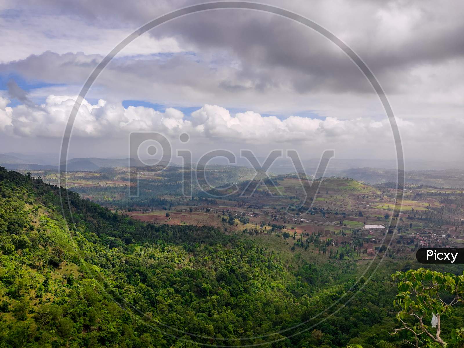 A View Of The Indian Mountains With Forest Trees And Cloudy Sky.