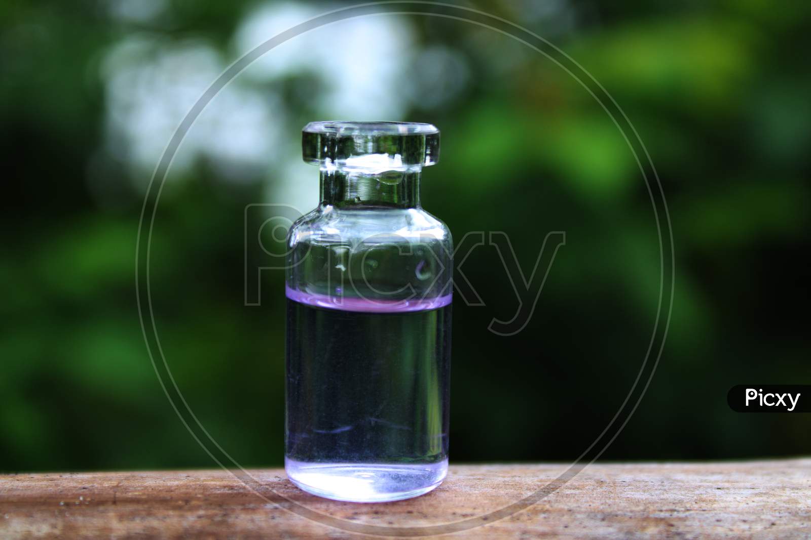 Water in the small bottle with natural background