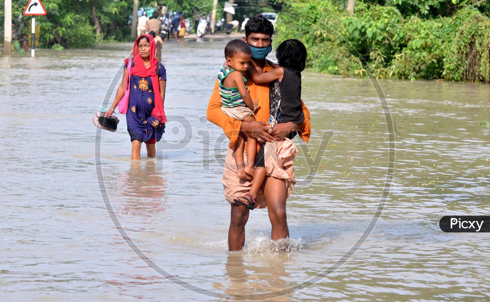 Villagers move to a safer place from the flood-affected areas in Hatisela district in Kamrup, Assam on July 14, 2020