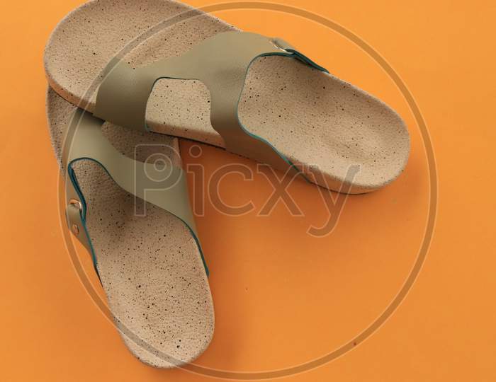 Slippers or Sandals on Orange Background