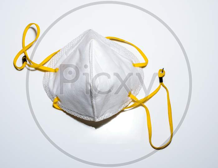 Isolated Face Mask For Use In Covid 19 Pandemic. Placed On A White Surface