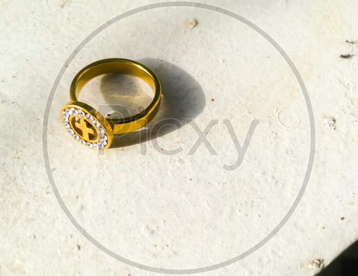 atop angle view of a golden ring placed on a white background.