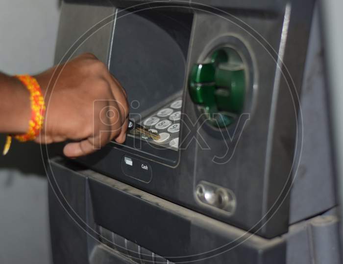 Man Using Atm Machine To Withdraw His Money. Closeup Of Hand Entering Pin Or Pass Code On Atm Machine Keypad,Security Code On Automated Teller Machine, Close Up Of Hand Entering Pin At An Atm.