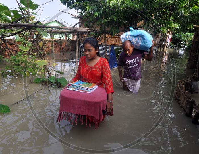 Villagers move to a safer place in the flood-affected areas of Hatisela in Kamrup, Assam on July 14, 2020
