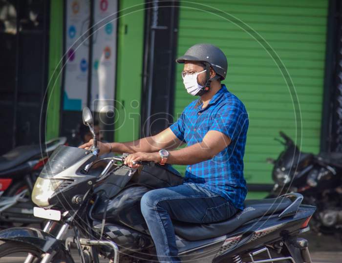 Hyderabad, Telangana, India. july-14-2020: man with protective safety mask on his face riding a motorbike, protective mask against corona virus