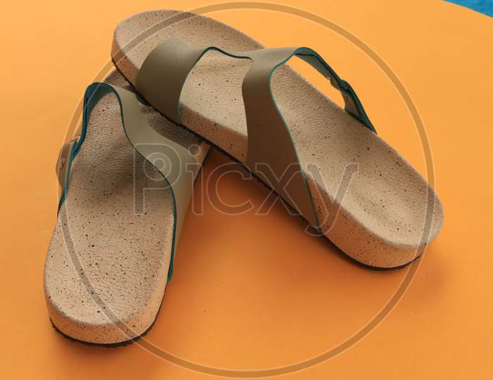 Slippers or Sandals on Orange Background