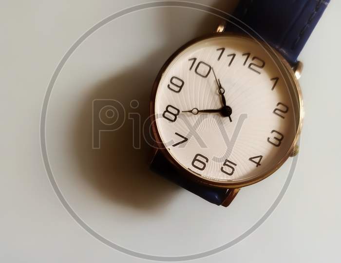 Analog wrist watch on white background